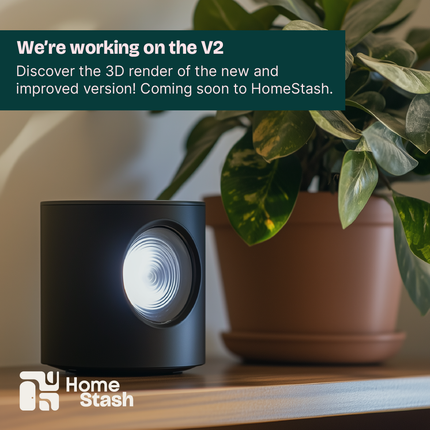 Compact blackmini projector on a wooden shelf next to a potted plant, emitting soft light. Integrates seamlessly in a minimalist and cozy atmosphere with warm natural tones.