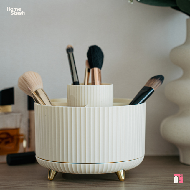 Brushes and beauty products neatly stored inside a modern and compact round beige makeup organizer.